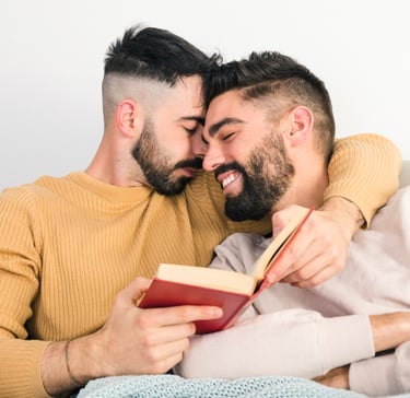 a gay sugar daddy with his sugar boy sitting on a couch
