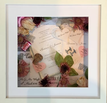 a memory box with keepsakes and a preserved wedding bouquet in a frame
