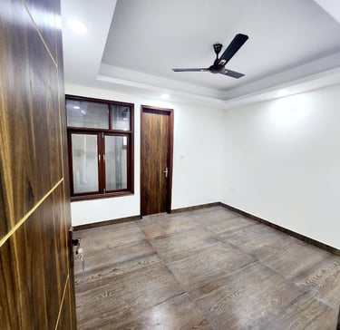 Spacious Bedroom of 3 BHK Builder Floor Near Sky Mansion Chattarpur with false ceiling and window