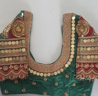a green blouse with gold coins and coins on it