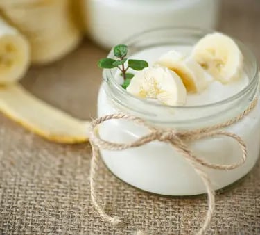 a jar of yogurt with bananas and yogurt