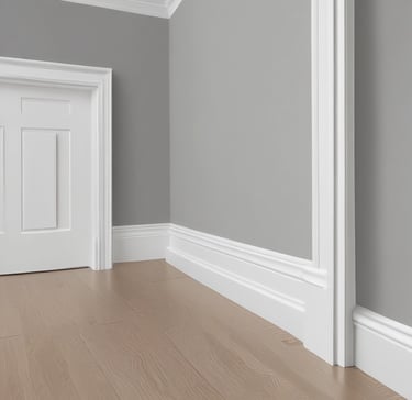 Close-up of a painter’s brush applying crisp white paint on navy blue trim.