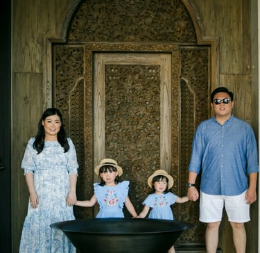 Family standing beneath the iconic Grand Lobby at The Apurva Kempinski Bali