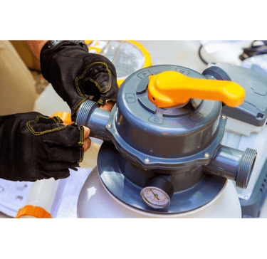 Pool tech with gloves on prepping a filtration system