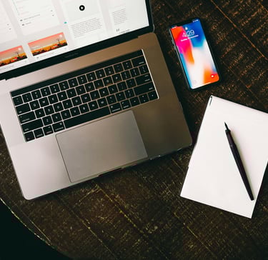 a laptop and a notebook on a table.Revenue Management for Hotels with Timea Pokol Consultant