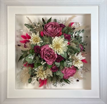 a Birdseye view Style bouquet of flowers in a rustic white frame