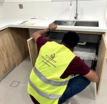 Civil Engineer inspecting under the basin for water leak
