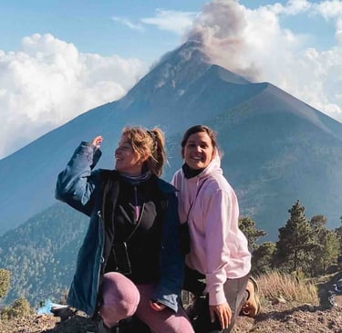Eva and Manon in front of the eruption of Fuego Volcano, Guatemala.