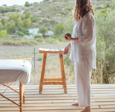 Sheila Doerfler in white linen activating the earth star energy center during group Biofield Tuning session in Spain