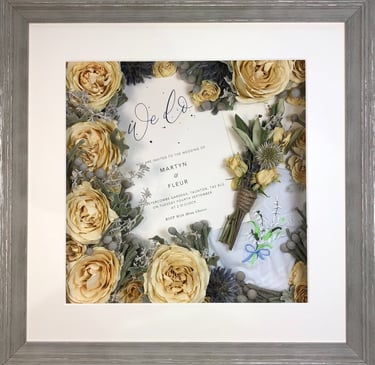 a memory box with keepsakes and a preserved wedding bouquet in a frame
