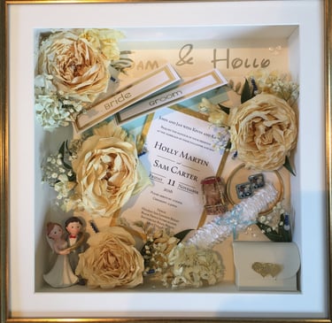 a Memory Box frame featuring wedding keepsakes and flowers