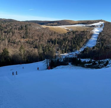 a ski slope with people skiing down it