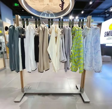 Smiley brand clothing rack featuring colorful windbreakers and hoodies in a retail apparel store.