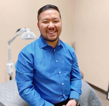 Dr. Xiong in a blue button-down shirt at Balance Naturopathic & Acupuncture Clinic.