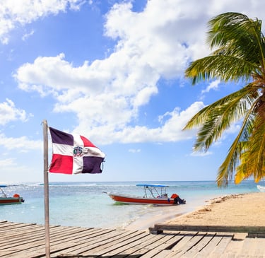 Saona Island Dominican Republic beach with flag palm trees boats and turquoise Caribbean sea