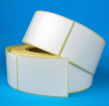 two rolls of white labels on a blue background