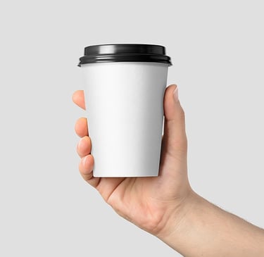 a person holding a cup of coffee in their hand