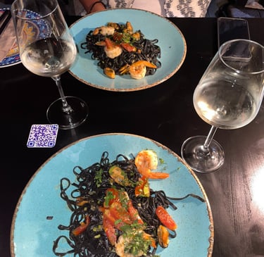 a plate of pasta with shrimp and pasta