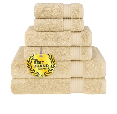 Stack of six plush white cotton towels, folded.