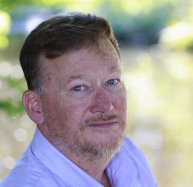 db gibb with a beard and a white shirt