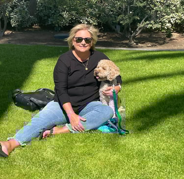 Kelly and Ollie sitting in green grass