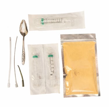 baby bird feeding formula in foil pouch with syringes and crop tubes and spoon