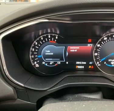 car dashboard display showing towing indicator