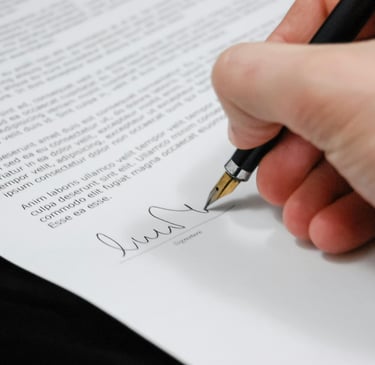 One right hand with a pen signing a contract