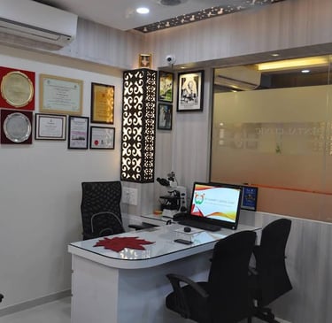 Professional dental clinic consultation room with certificates on the wall and a modern doctor desk.