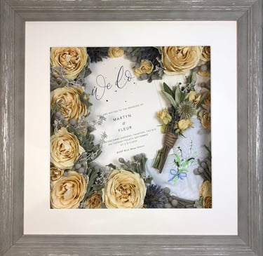 a memory box with keepsakes and a preserved wedding bouquet in a frame