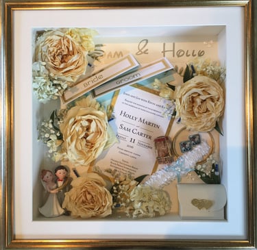 a Memory Box frame featuring wedding keepsakes and flowers