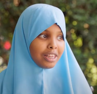 a young girl wearing a blue hijab hijab hijab hi