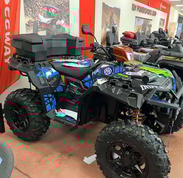 Custom blue and black Segway ATV with storage box displayed in a powersports showroom.
