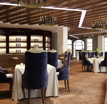 Restaurant interior with dining tables, purple chairs, a bar, and chandeliers.