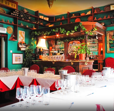 a restaurant with a bar and a bar with wine glasses