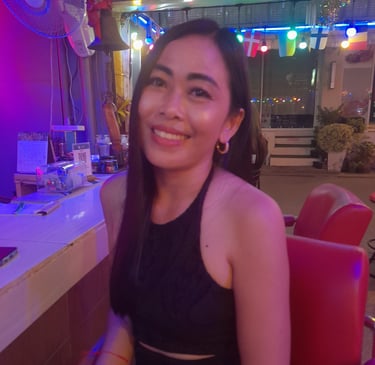 Thai woman sat in bar on Soi 80, Hua Hin in Thailand