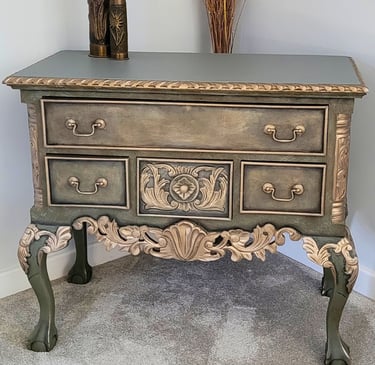 A Chippendale repro painted in different tones of green layers with gold highlights to the detail