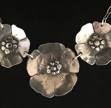 three beach roses on a necklace in sterling silver