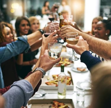a group of people toasting with glasses of wine