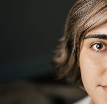 A partial image of a woman with rounded eye shapes