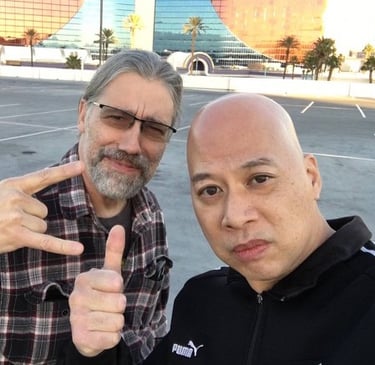 Ray and Chance wolf posing in a Las Vegas parking lot with the Rio Hotel in the background.