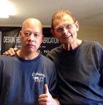 Ray and Tom Mullica posing together in a fabrication shop, featuring KMD Kustom magic design