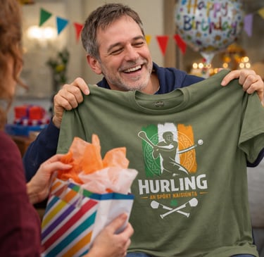 Smiling man opening a gift containing a green Irish hurling t-shirt at a birthday party.