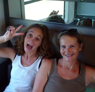 headshot of two backpackers on a train in France