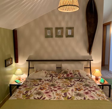 earth bedroom with a bed and a lamp