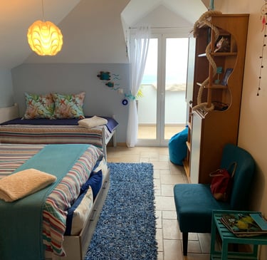 water bedroom with two beds and a chair