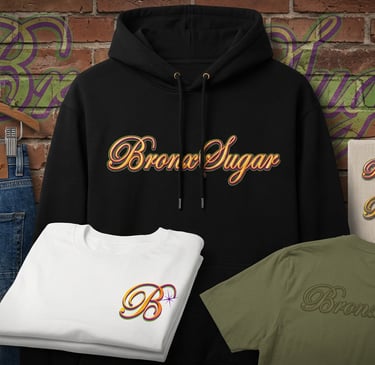 Bronx Sugar branded black hoodie and t-shirts displayed with denim jeans against a brick wall background.