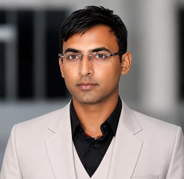Professional headshot of a man in a beige suit jacket and glasses, perfect for a LinkedIn profile.