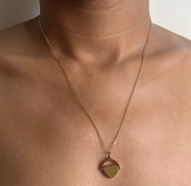 Delicate gold necklace with heart-shaped pendant