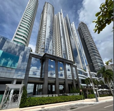 a city street scene with a large building in the background